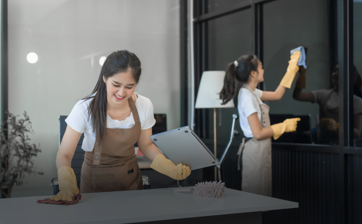 Women cleaning office surfaces and windows