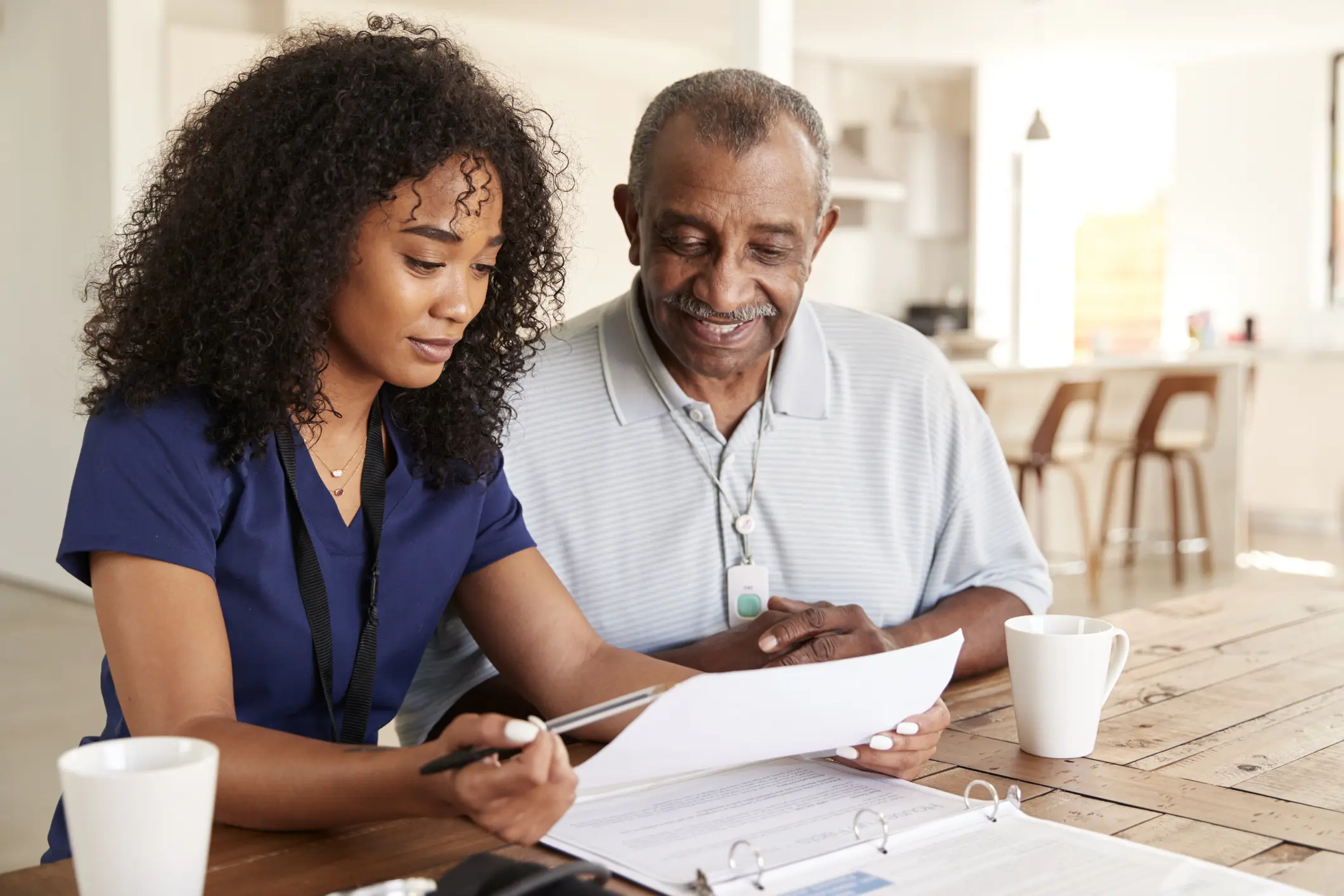 Senior man consulting with a caregiver