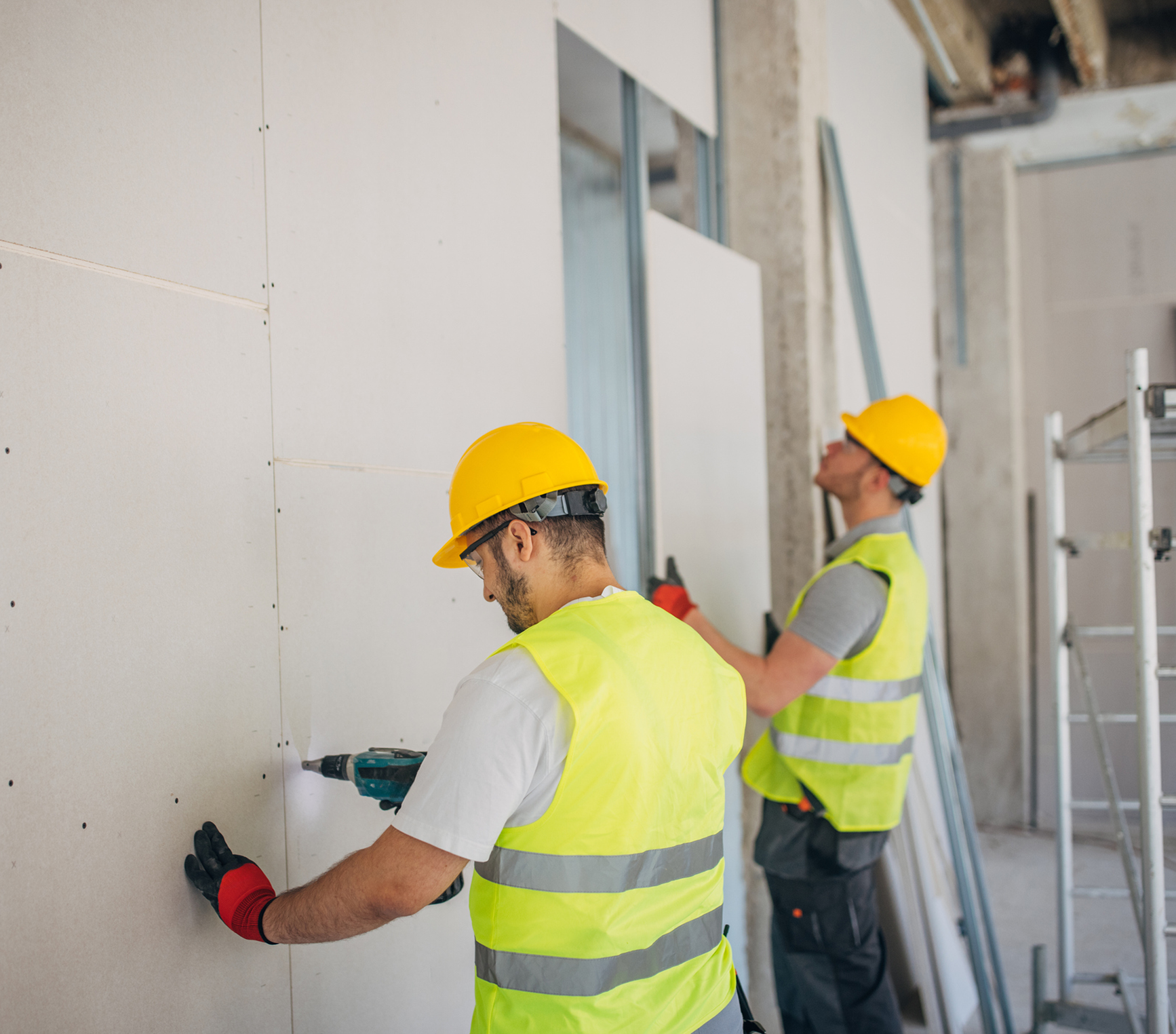 Builders wearing safety vests and helmets
