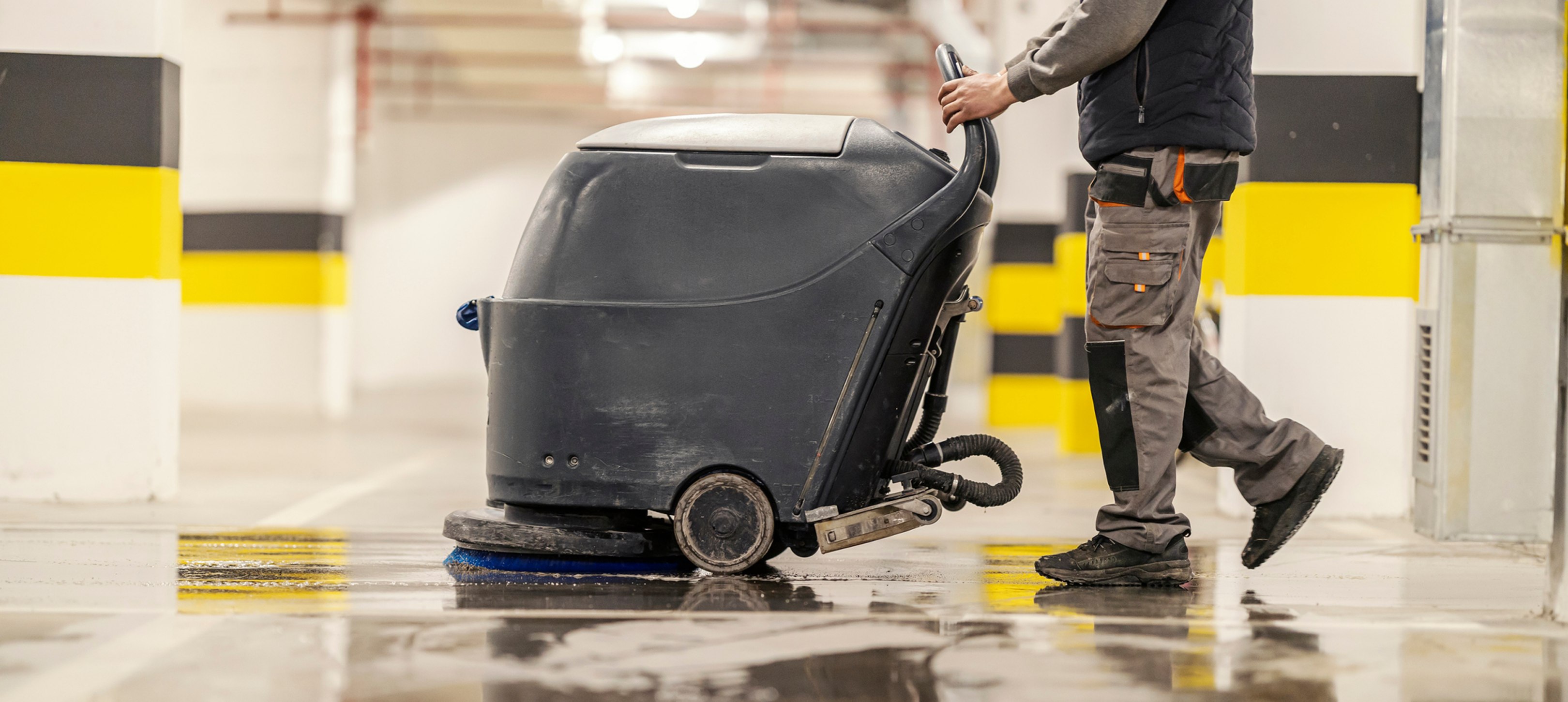 Worker operating floor cleaning machine