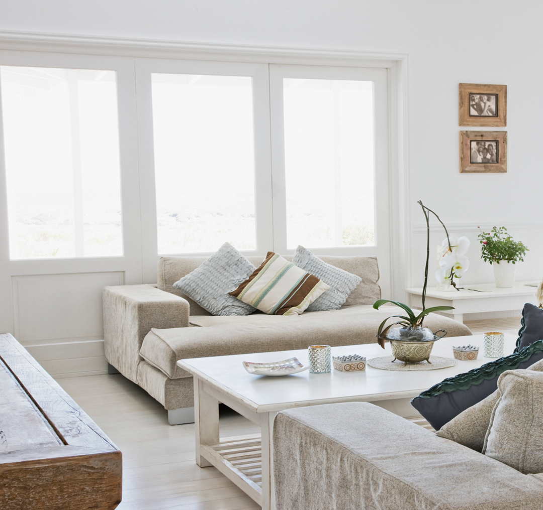 Bright room featuring large windows and sofas