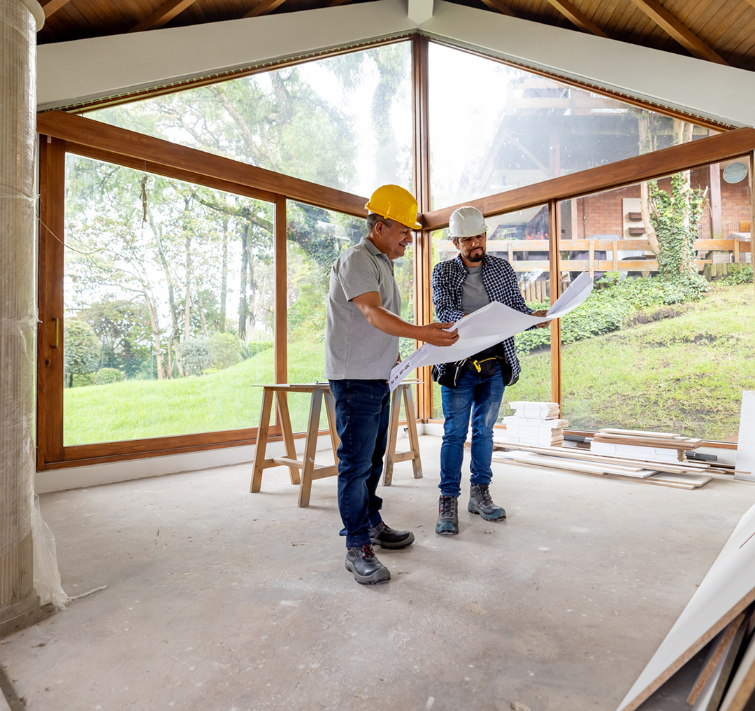 Two builders discussing project indoors