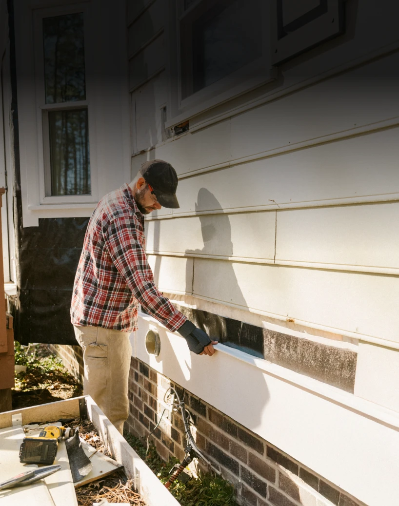 Worker repairing exterior wall